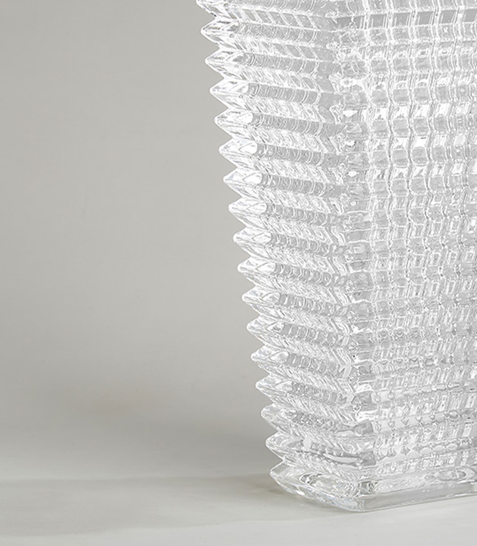 Close-up of clear glass vase with textured grid design.
