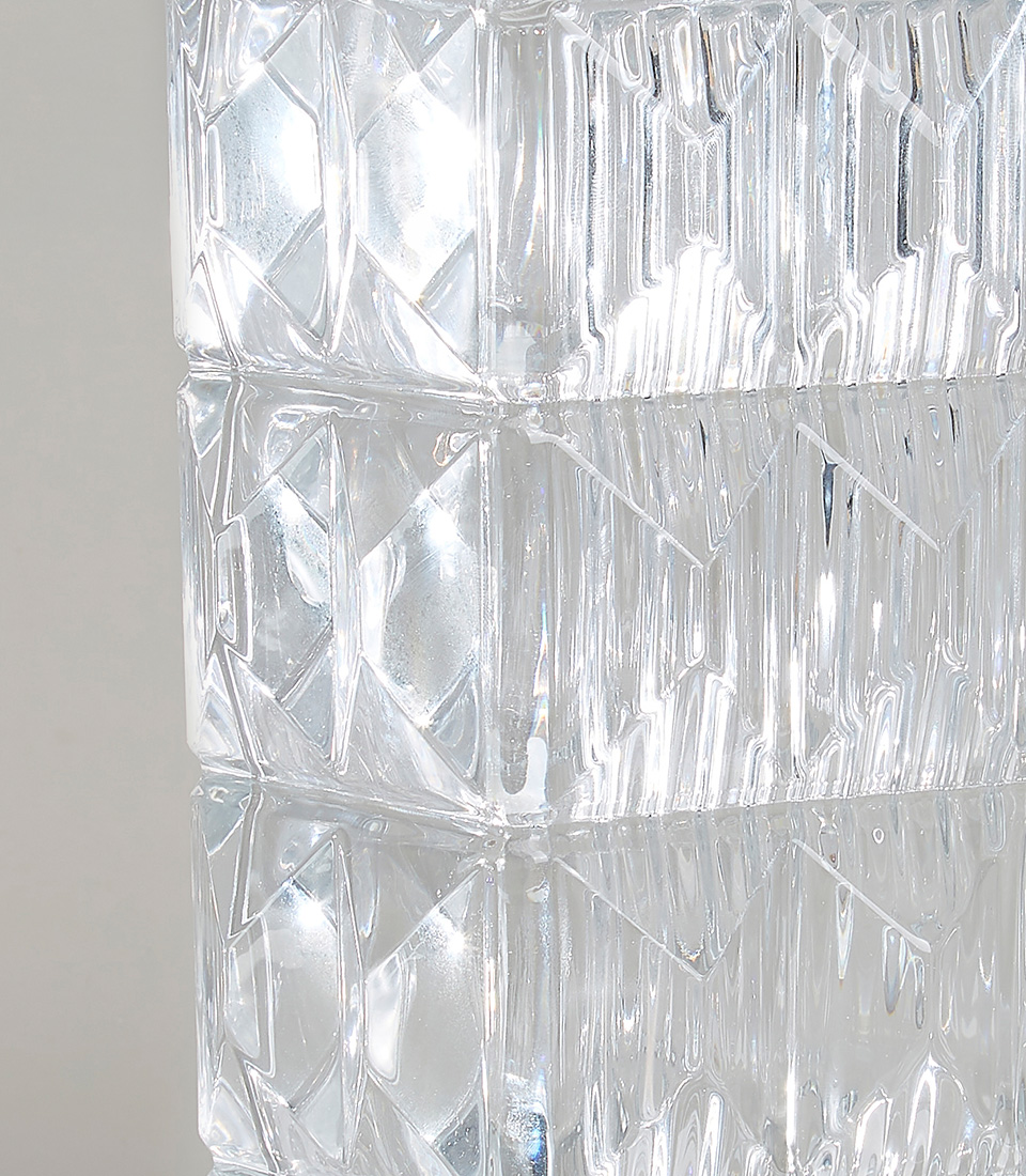 Close-up of clear glass vase with geometric diamond pattern.