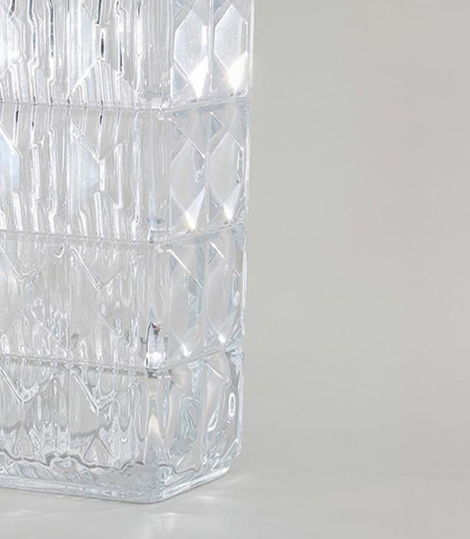 Close-up of clear glass vase with geometric diamond pattern.