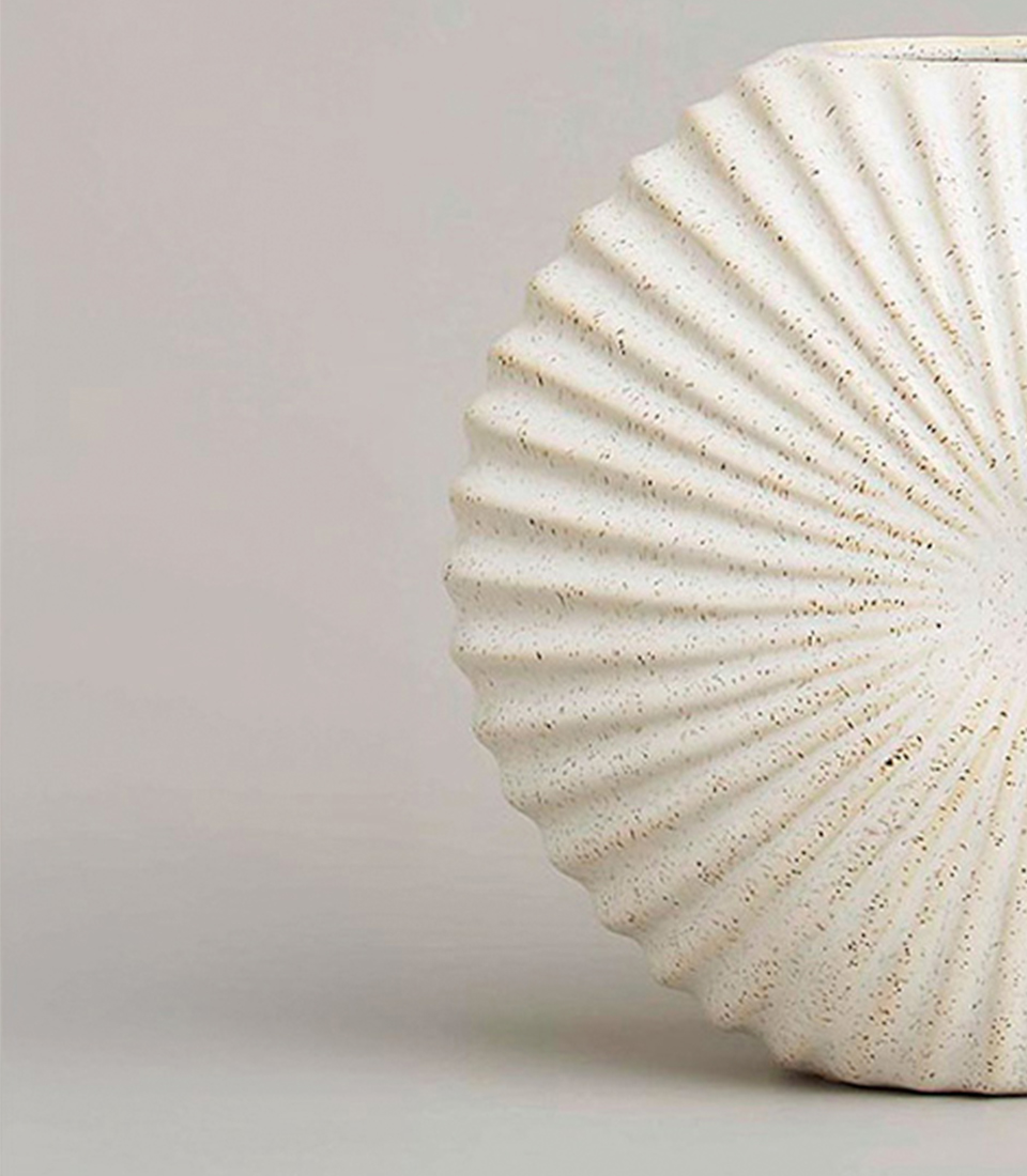White ceramic vase with fan-shaped ribbed texture