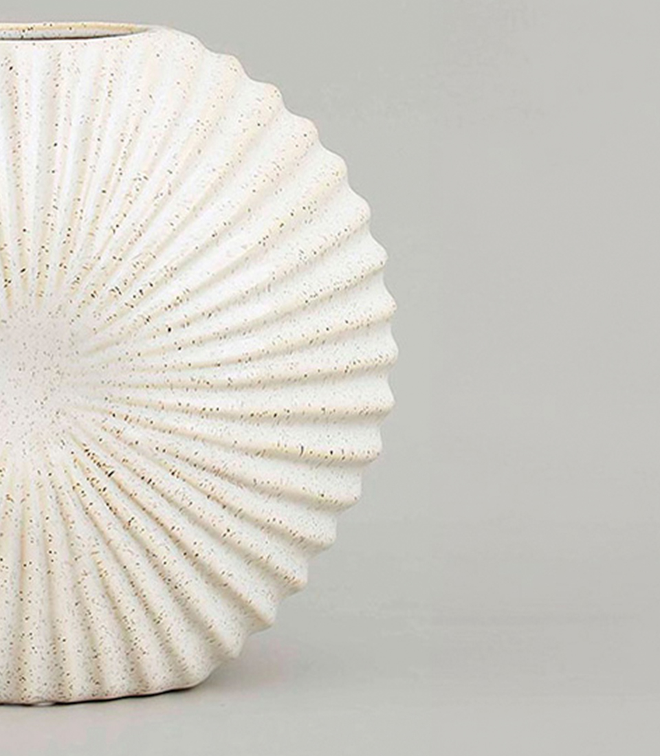 White ceramic vase with fan-shaped ribbed texture