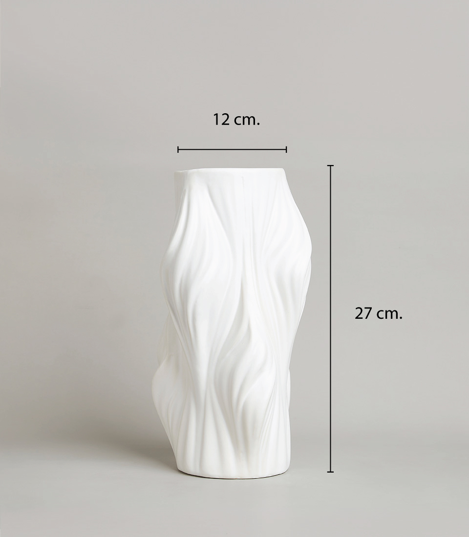 White ceramic vase with a flowing wave design , placed on a light grey background and dimensions 12 cm x 27 cm.