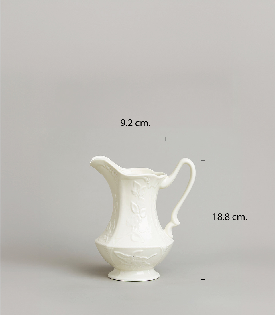 White Ceramic Pitcher with Floral Embossed Design and Measurements Dimensions 18.8 cm x 9.2 cm., on a light grey background.