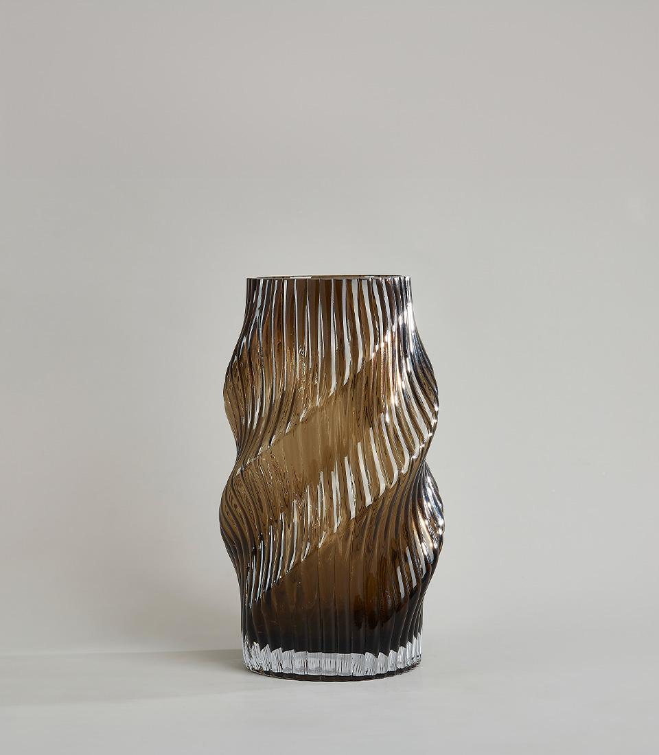 Glass vase with a spiral pattern and smoky amber color, showcasing modern elegance and craftsmanship