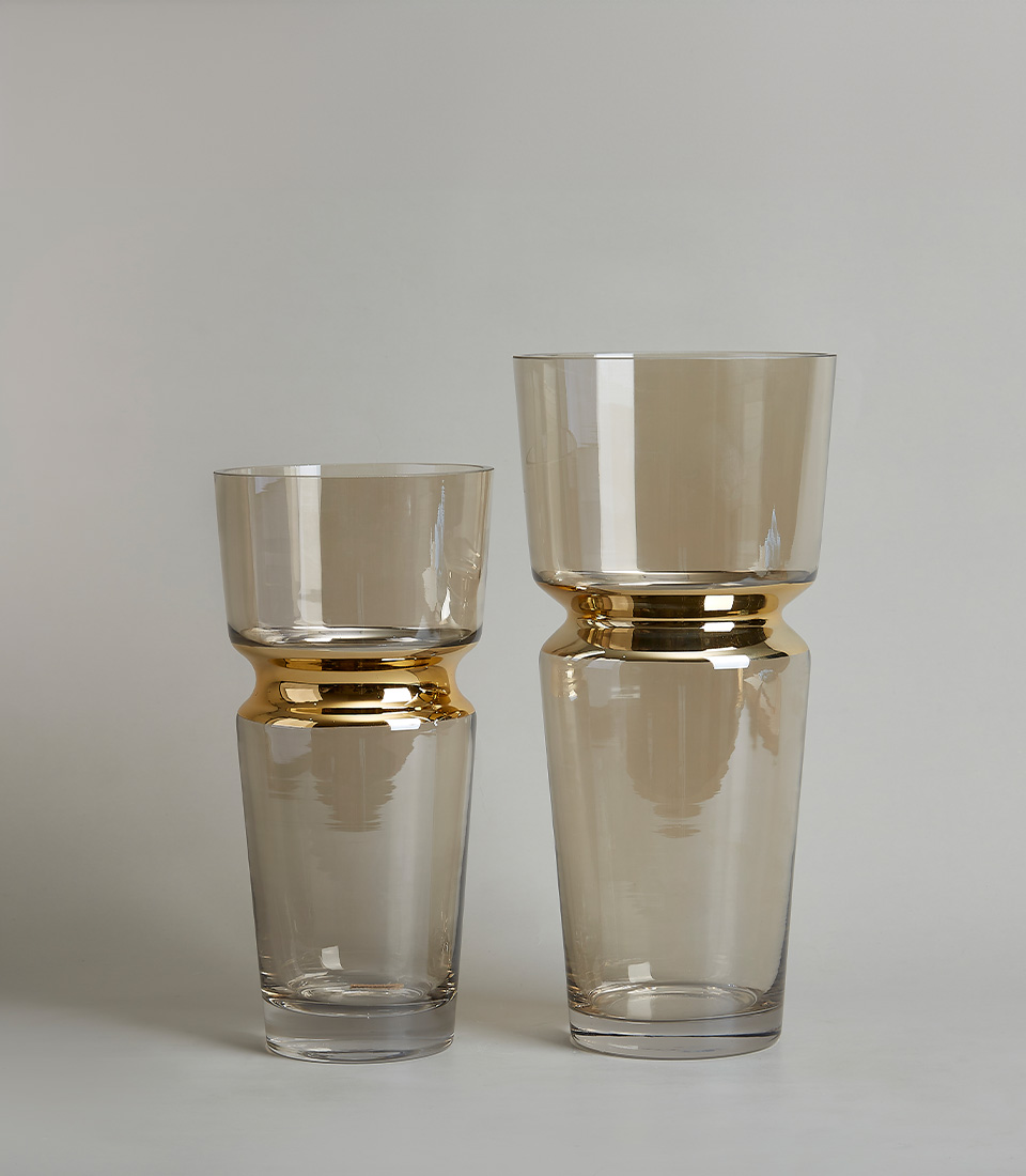 Duo Clear glass vase with a gold band around the middle on a light gray background.