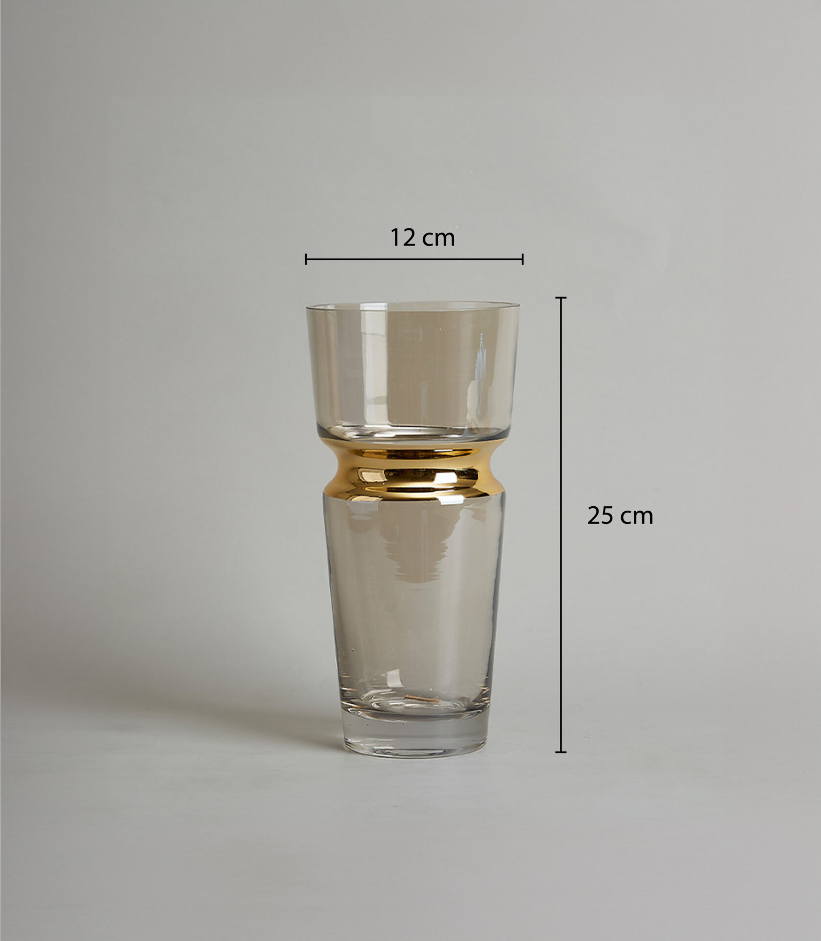 Clear glass vase with a gold band around the middle, 25 cm. tall and 12 cm. wide, on a light gray background.