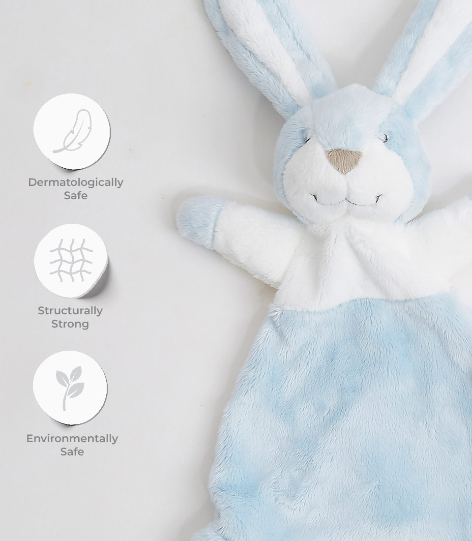 A soft blue and white plush bunny toy is displayed on a light background. To the left, three icons with text indicate that the cute bunny toy is dermatologically safe, structurally strong, and environmentally safe—perfect for a baby's playful moments.