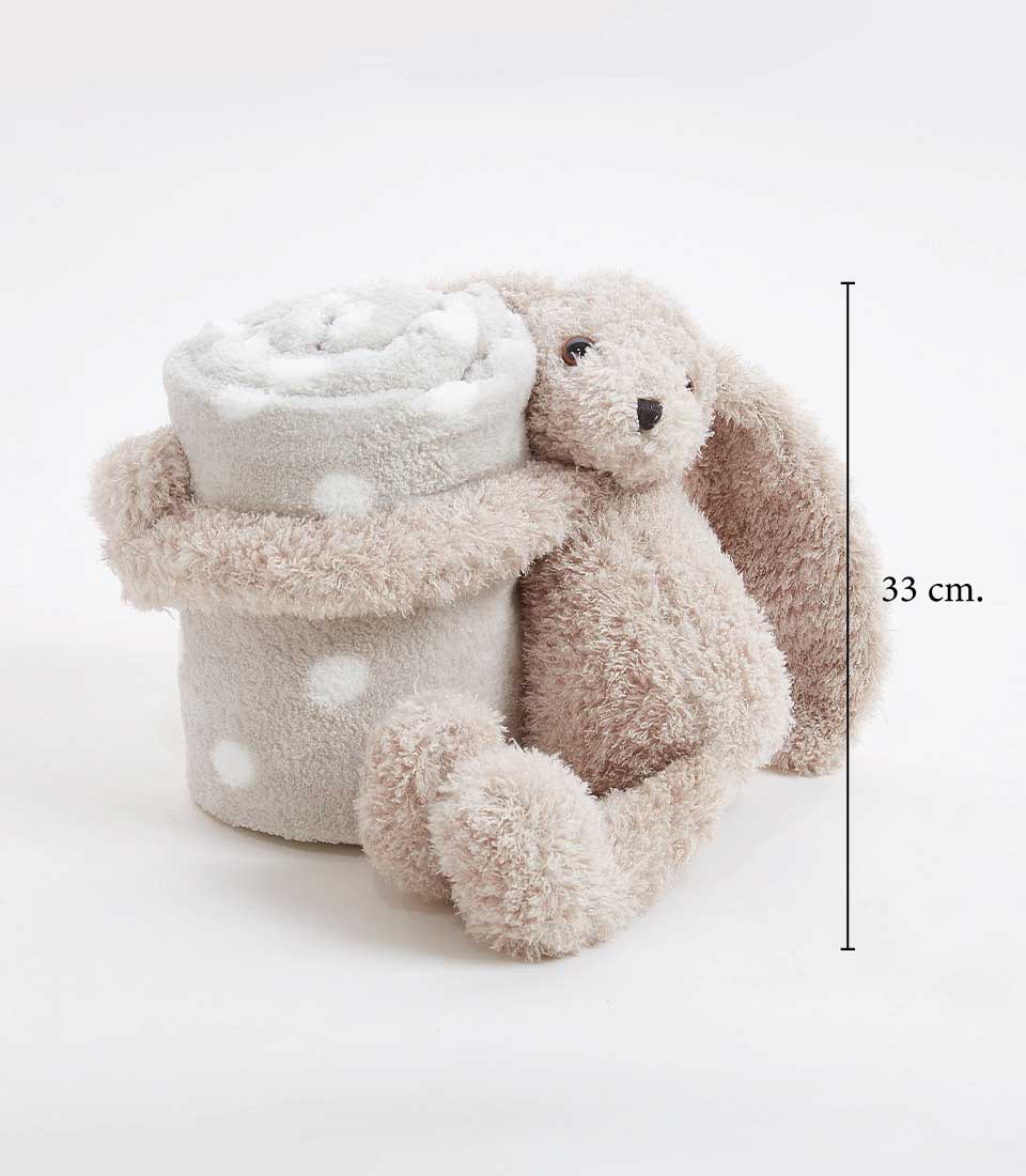 A cozy Bunny Plush hugs a rolled-up, gray blanket with white polka dots. The bunny's arms and legs are wrapped around the baby blanket, and its long ears hang down. A measurement line next to this delightful soft toy indicates its height as 33 cm.