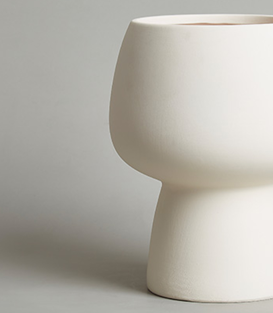 Close-up view of a modern white ceramic vase with a minimalist design.
