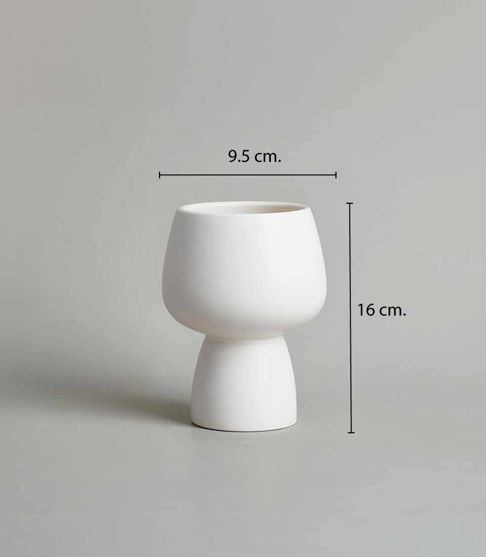 Modern white ceramic vase with a minimalist design, featuring a rounded bowl-shaped top and a narrow base, with dimensions of 9.5 cm width and 16 cm height, against a neutral background.
