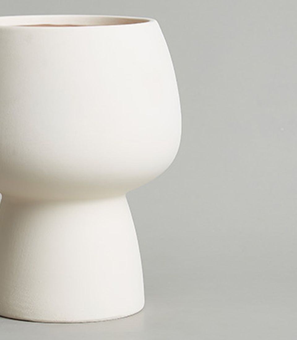 Close-up view of a Minimalist White Ceramic Sculptural Vase.