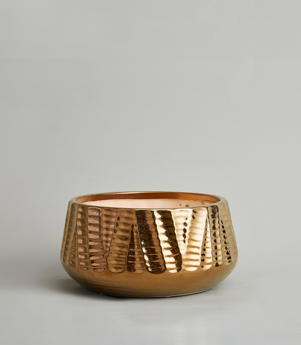 Metallic bronze textured ceramic vase with a wide, round shape against a neutral background.