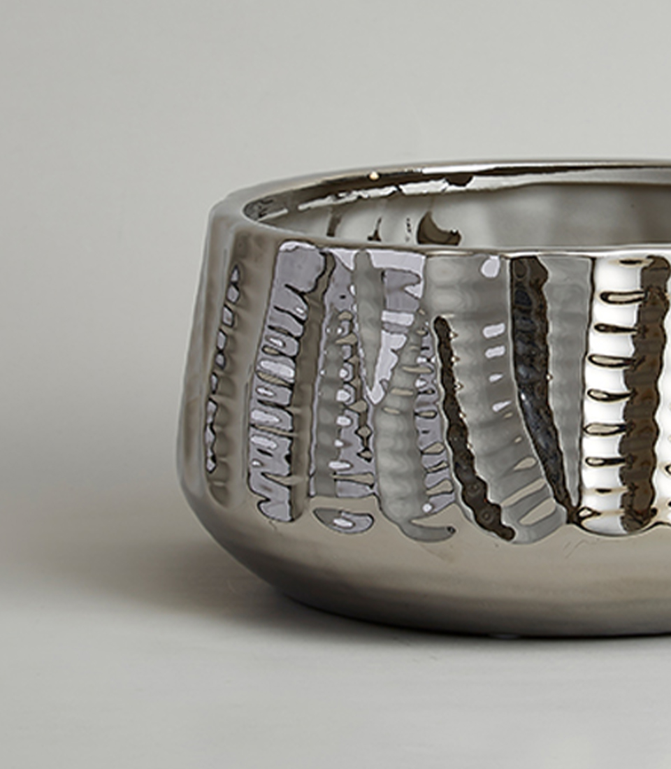 Close-up of a Wide round metallic silver textured ceramic vase.