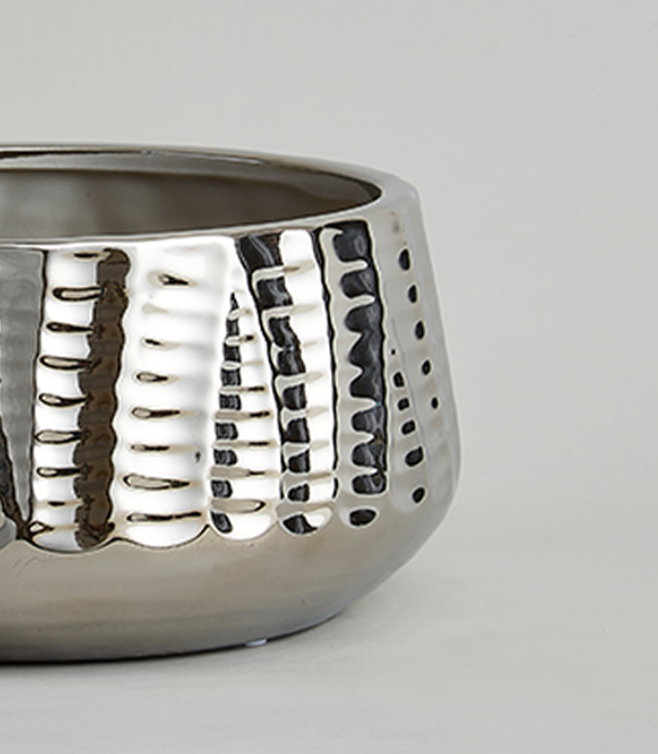 Close-up of a Wide round metallic silver textured ceramic vase.