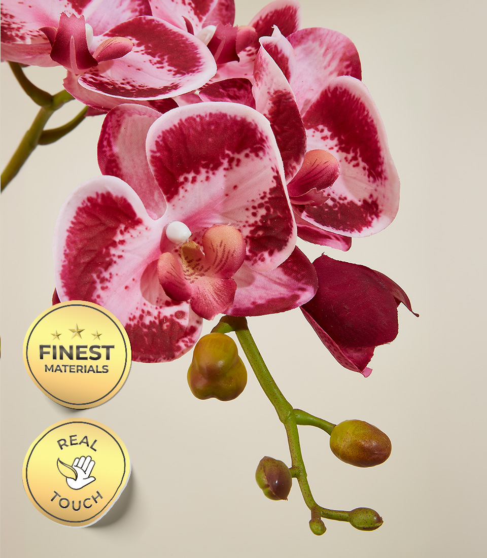 Close-up view of an elegant pink artificial orchid with real touch petals, showcasing the finest materials used, alongside a quality and touch assurance badge.