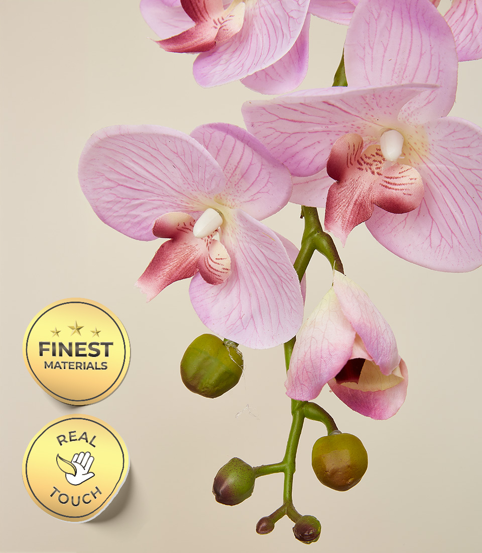 Close-up of lifelike pink artificial orchid flowers with green buds, showcasing the 