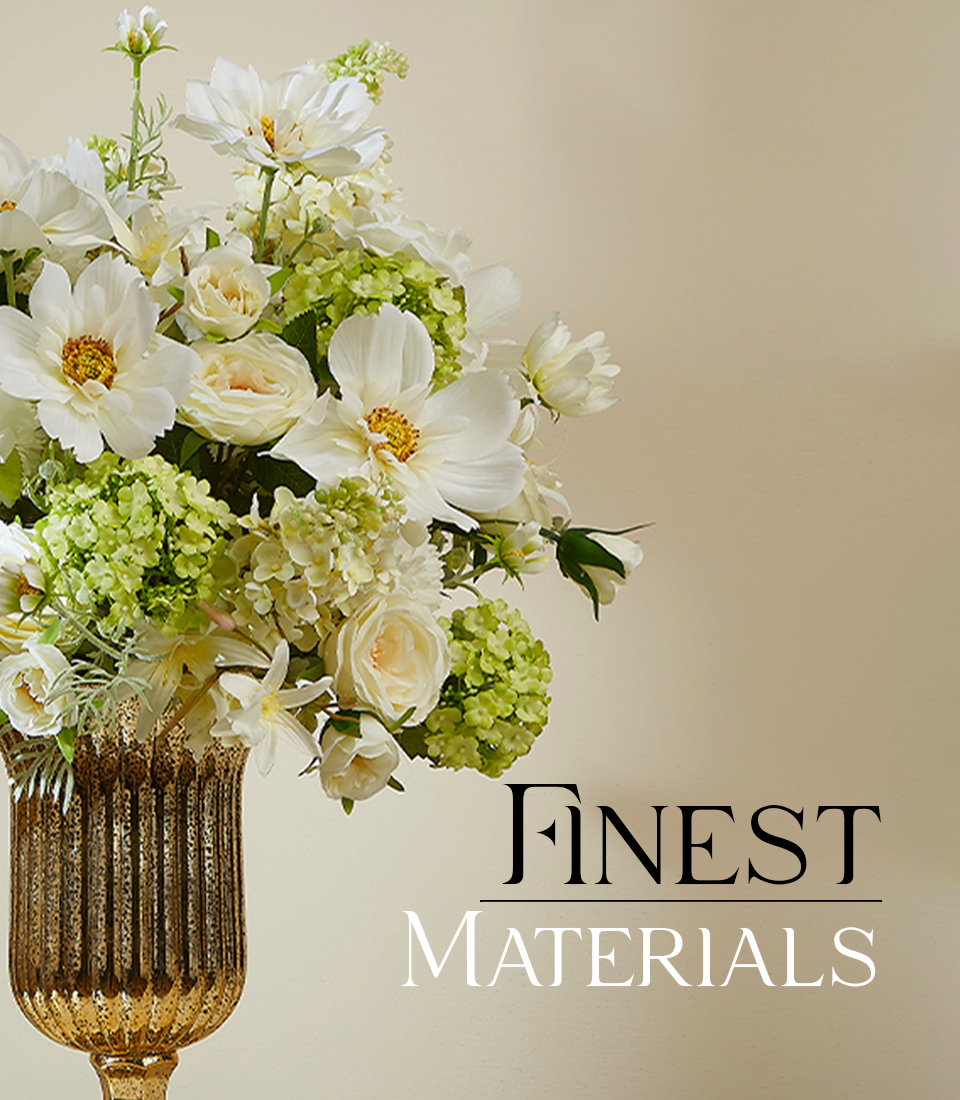 Elegant artificial flower arrangement featuring lifelike white roses, daisies, and green hydrangeas in a luxurious gold vase with the text 