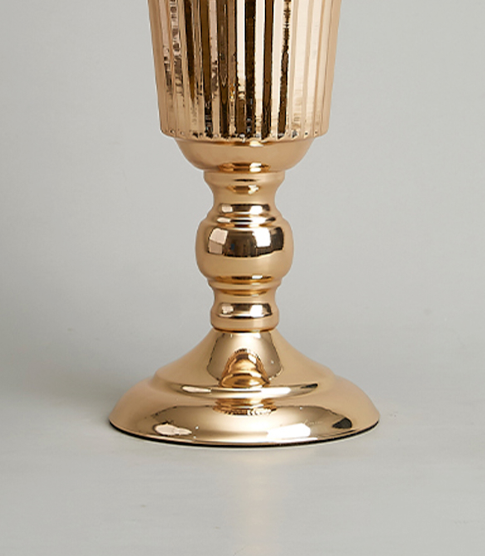 Close-up view of the base of a gold-plated stainless steel vase with a modern fluted design.