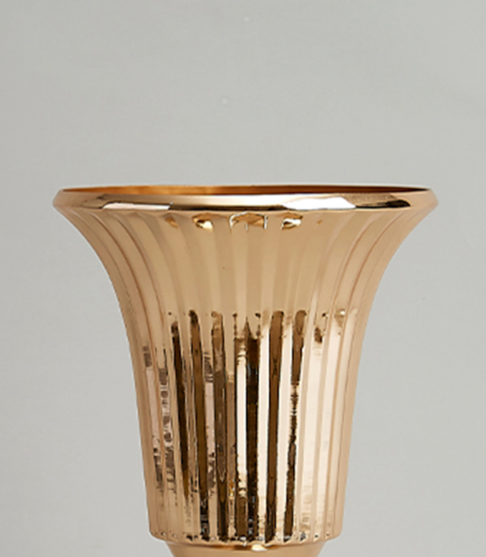 Close-up view of Elegant gold-plated stainless steel vase with a modern fluted design.