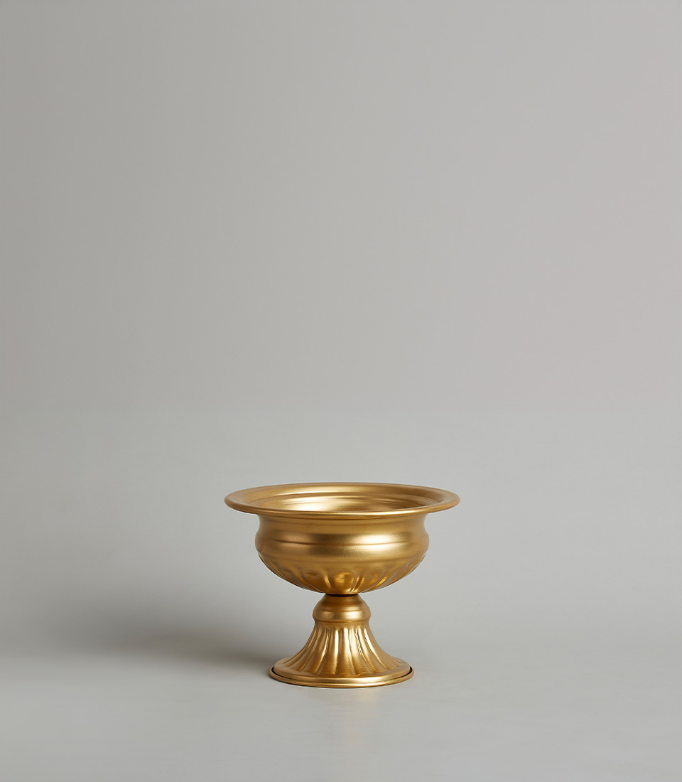 Elegant gold steel pedestal vase with a wide bowl and fluted base design, on a light grey background.