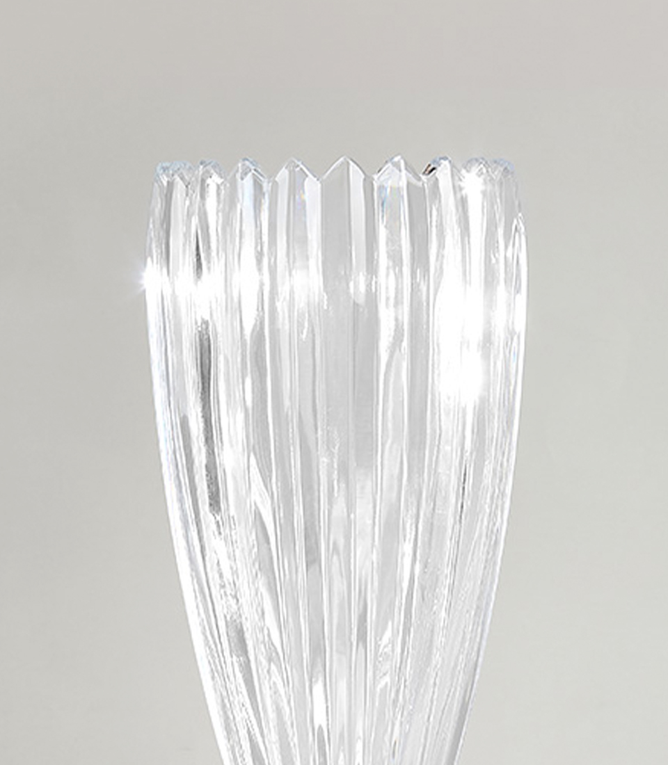 Close-up of Tall crystal glass mirror vase with intricate faceted design on a white background.