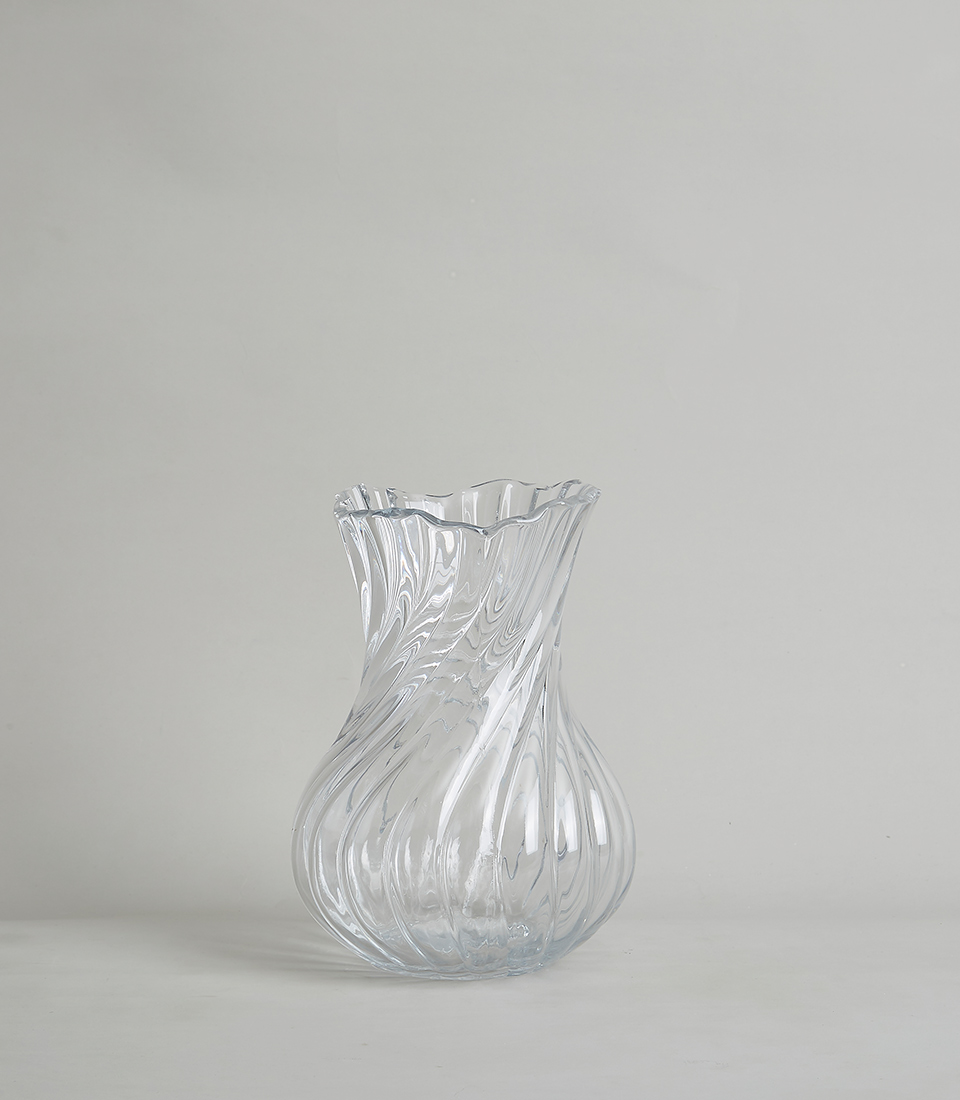 Elegant crystal vase with a swirl design on a white background.