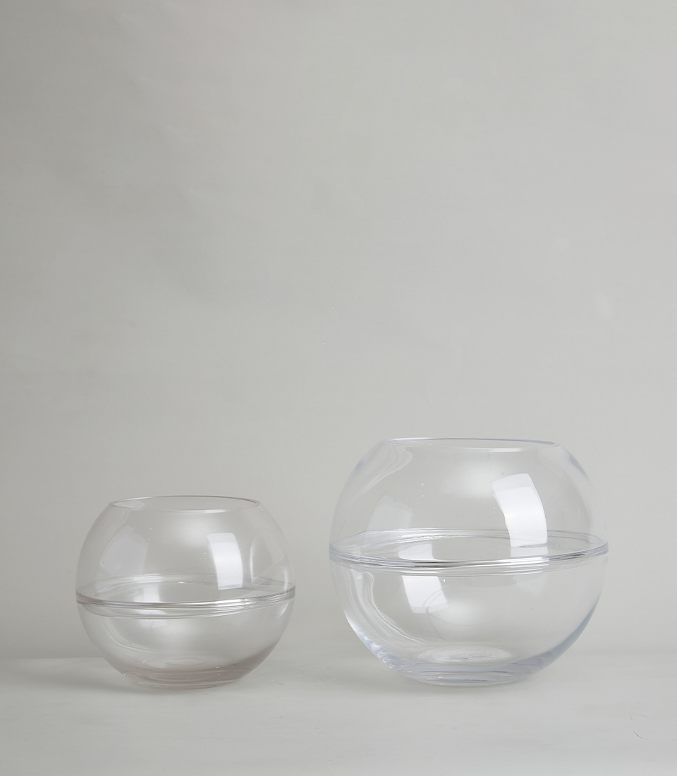 Set of two clear glass bubble vases, perfect for modern home decor on a white background.