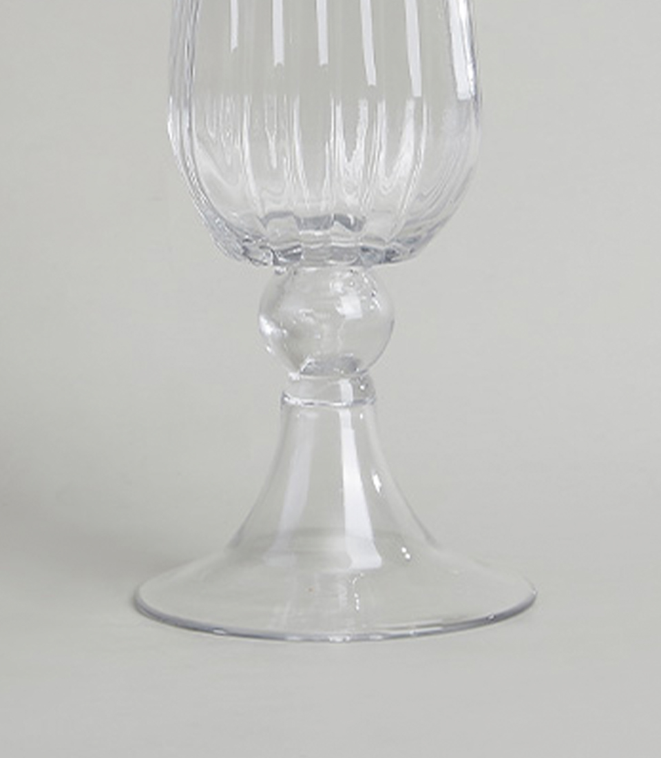 Close-up of an elegant ribbed glass vase with a fluted design.