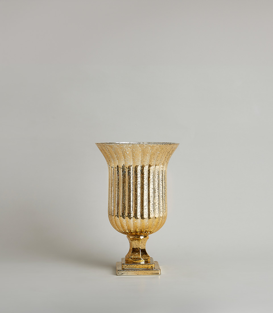 Gold fluted vase with a textured design and square base, on a light gray background.