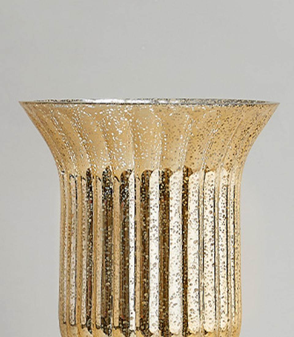 Close-up view of an elegant gold fluted vase showcasing its detailed texture and design.