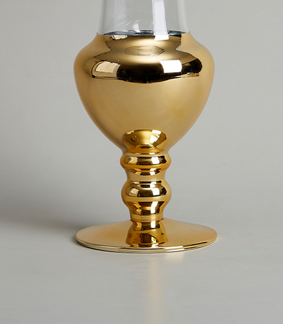 Close-Up of Gold Base of Elegant Glass Vase with Reflective Finish.