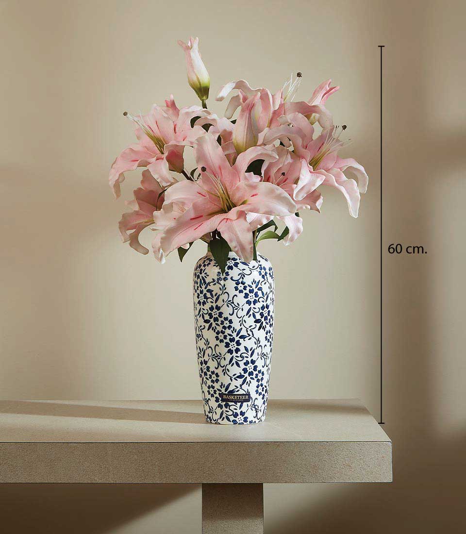 Artificial pink lilies in a blue and white ceramic vase on a table, displayed on a beige background, featuring a height measurement of 60 cm.