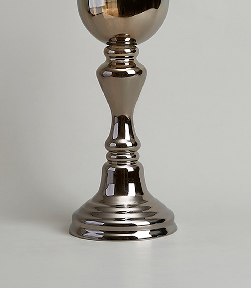 Close-up view of the pedestal base of a silver glass vase, showcasing its elegant reflective finish and sturdy construction.
