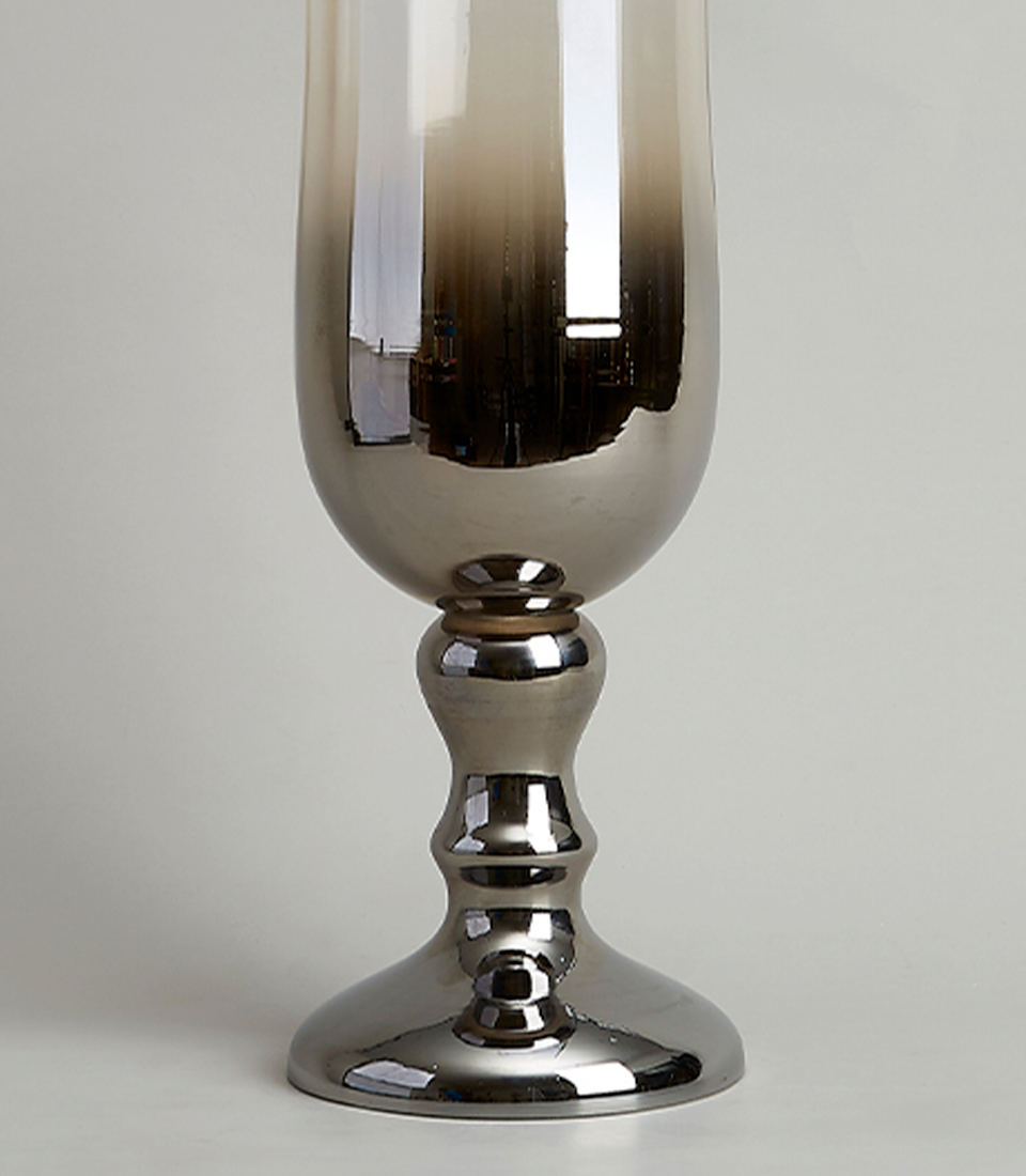 Close-up view of the pedestal base of a silver glass vase, showcasing its elegant reflective finish and sturdy construction.