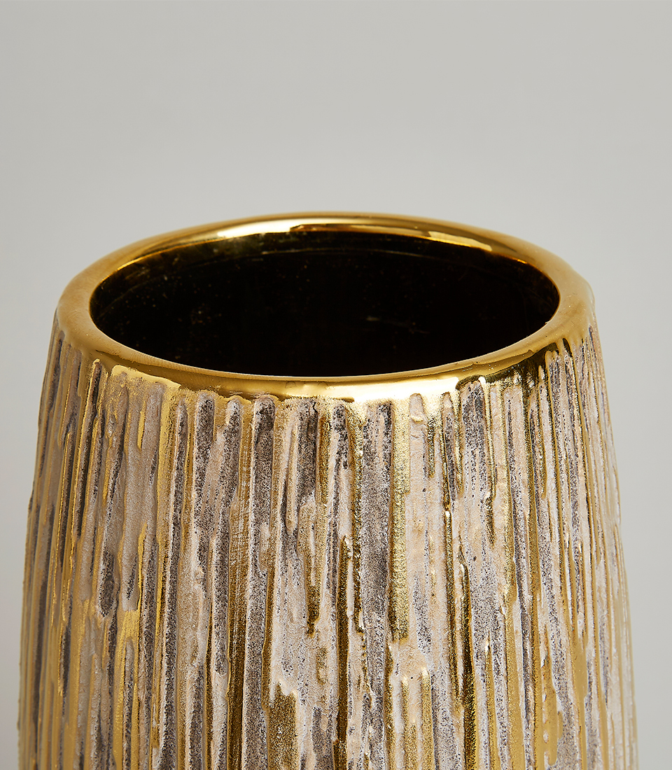 Close-up of an elegant gold textured vase with intricate details, perfect for home décor.