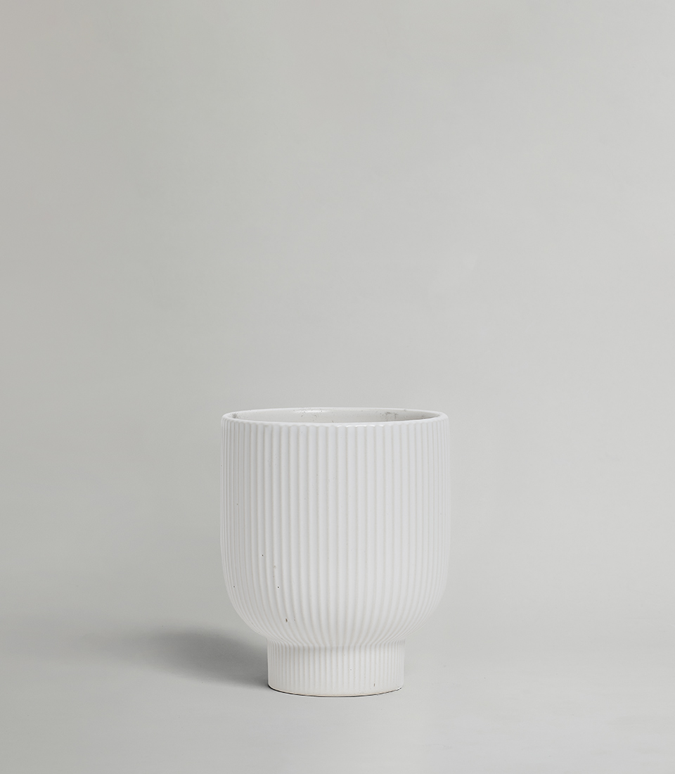 Modern White Ribbed Ceramic Vase on a light gray background.