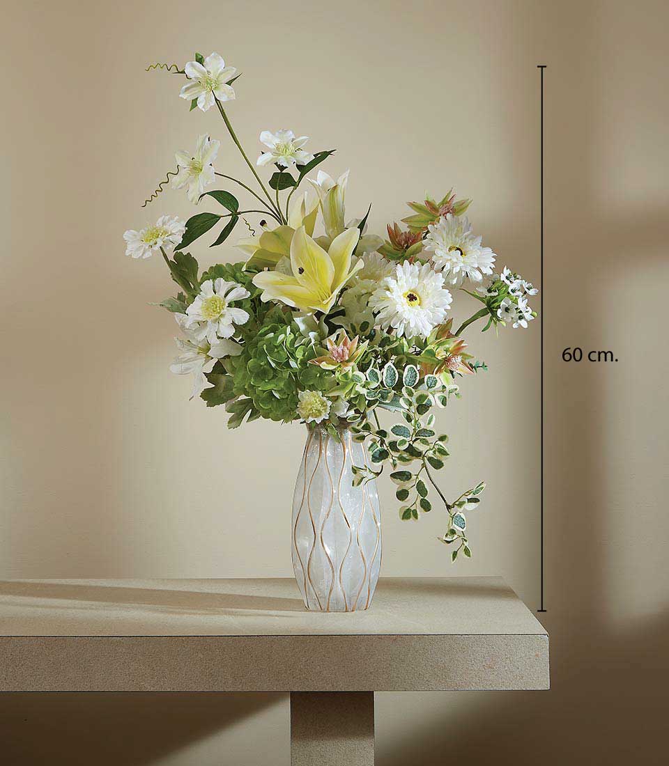 Artificial flower arrangement featuring white lilies, daisies, green hydrangeas, and foliage in a modern textured vase, displayed on a beige background, featuring a height measurement of 60 cm.