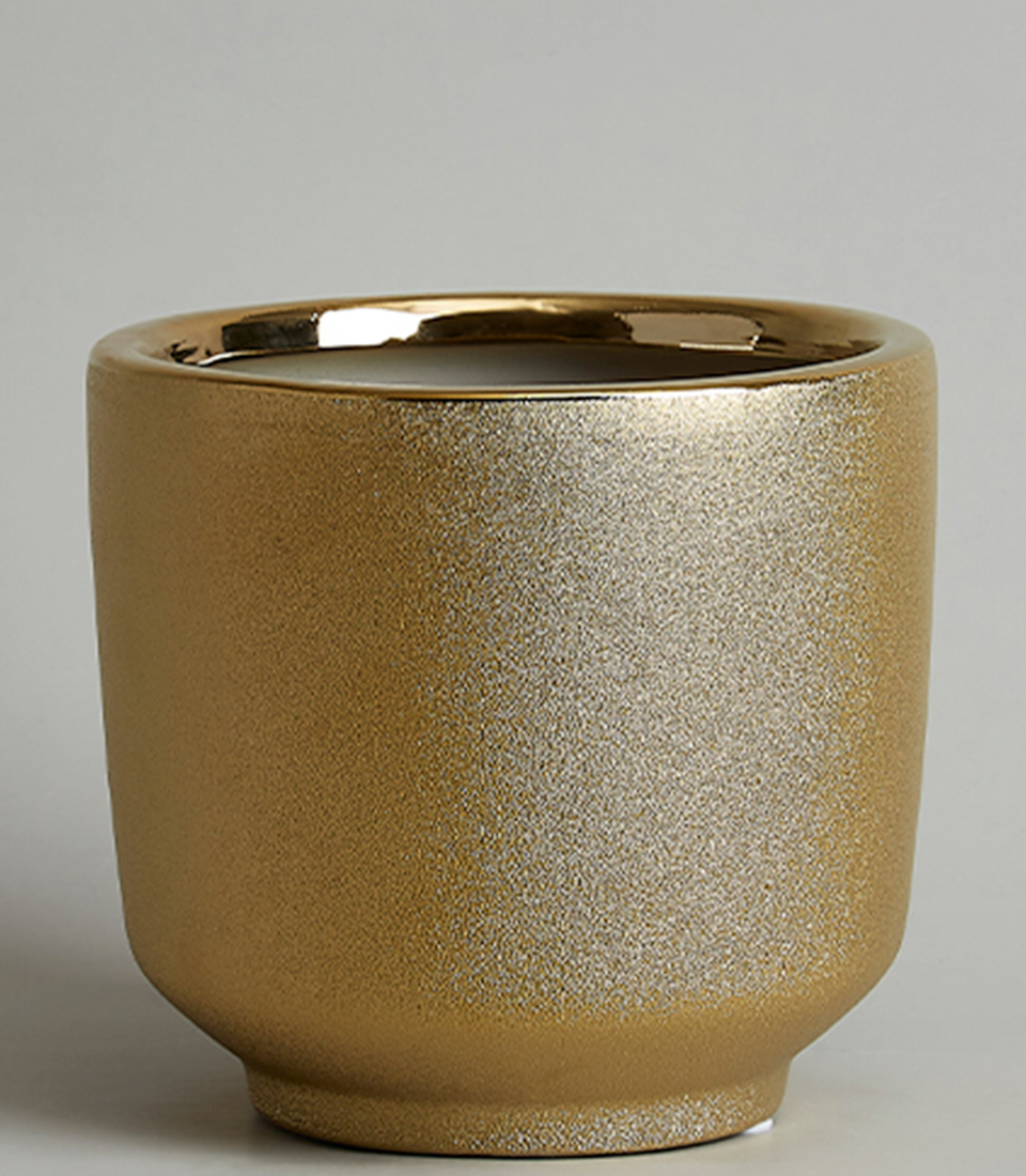 Close-up of an Elegant gold ceramic vase with a shimmering finish.