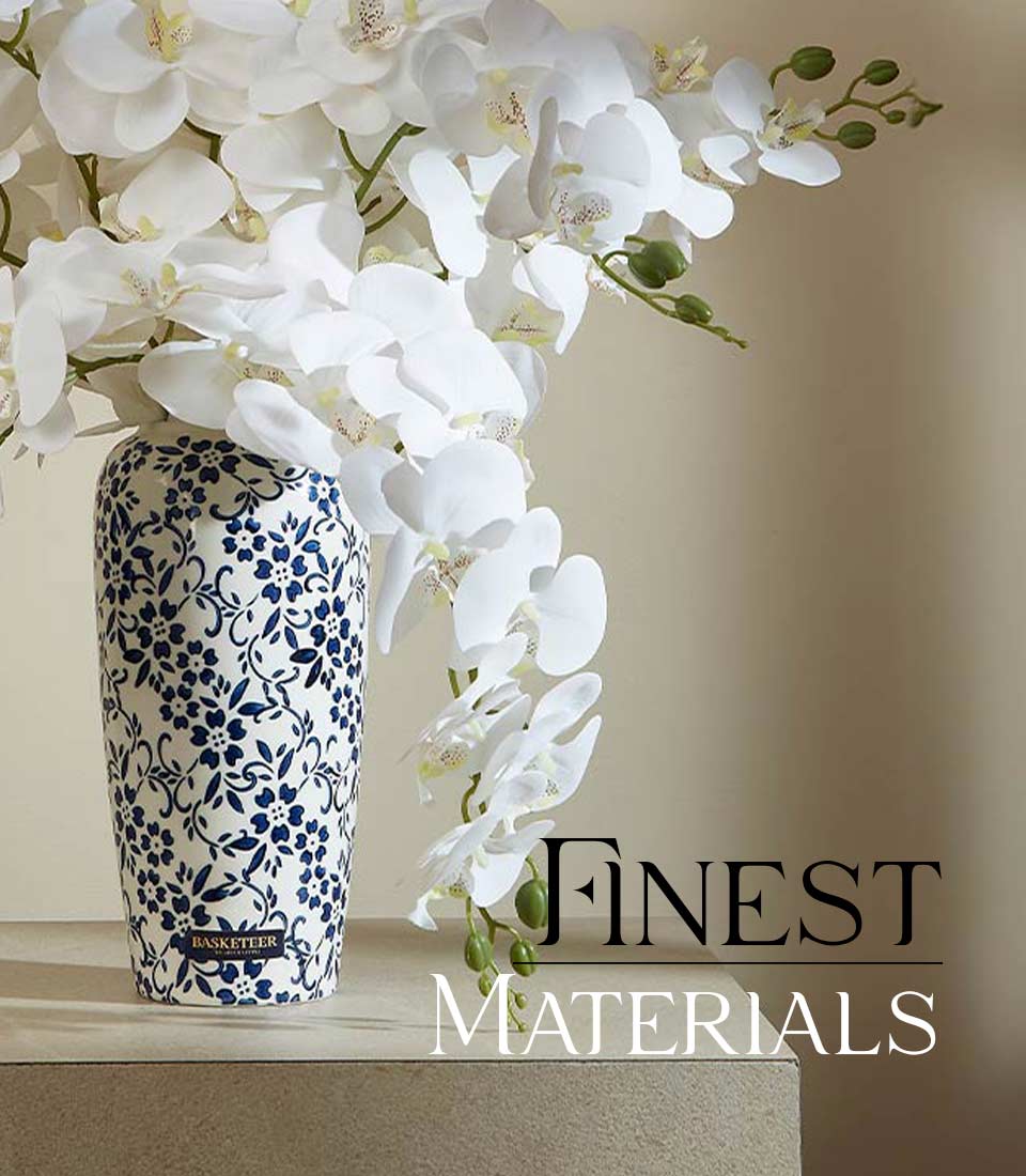 Close-up of Artificial white orchids in a blue and white ceramic vase with floral patterns , with a 