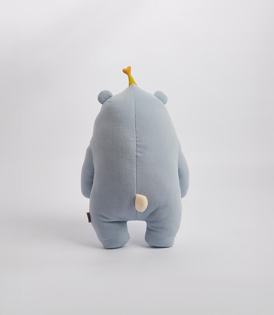 A charming blue bear plush toy wearing a small yellow party hat, on a white background.