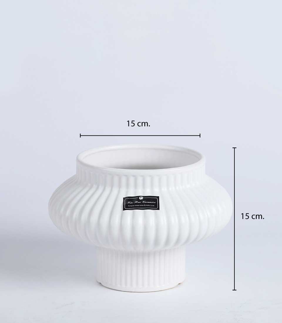 White ribbed ceramic vase with a unique flared design, 15 cm in height and diameter on a white background.