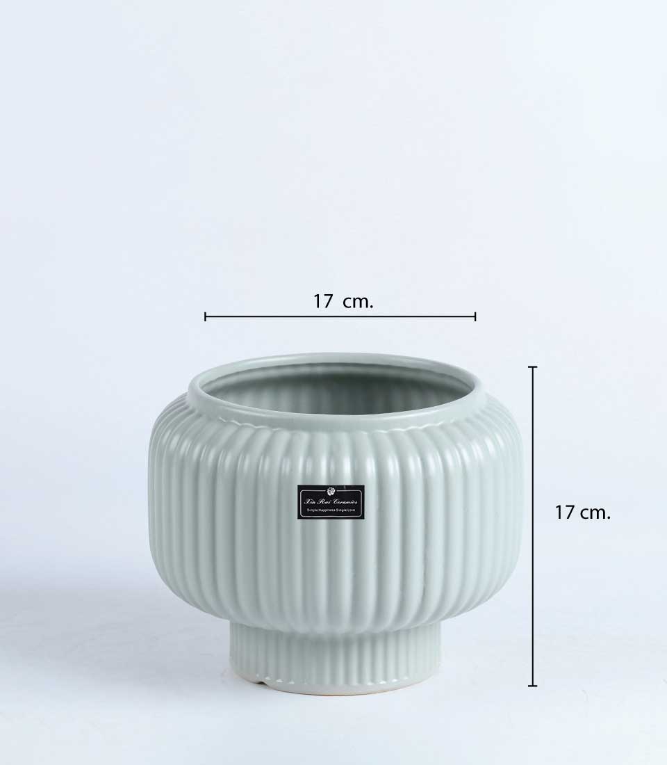 Light green ribbed ceramic vase with elevated base and dimensions indicated: 17 cm diameter and 17 cm height.