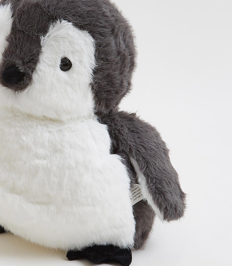 Small, black and white plush toy penguin chick