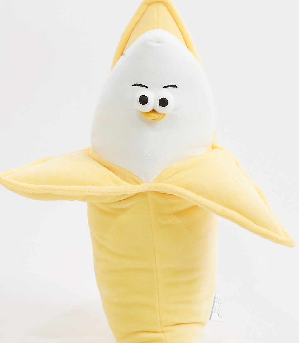 close-up of a cute and whimsical banana plush toy, featuring a playful expression with wide eyes and a slight smile. The plush is soft and yellow, with an open peel design