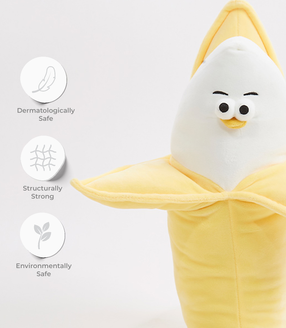 Close-up of a plush banana toy with a smiling face, showcasing its dermatologically safe, structurally strong, and environmentally safe features.