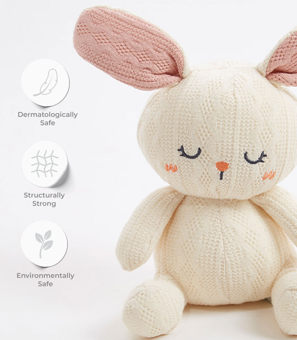 Handcrafted crocheted bunny plush toy, with a soft cream exterior and pastel pink ears. The bunny features a sweet, sleepy face with embroidered eyes and an orange nose. It is dermatologically safe, structurally strong, and environmentally safe, making it perfect for newborns and young children.