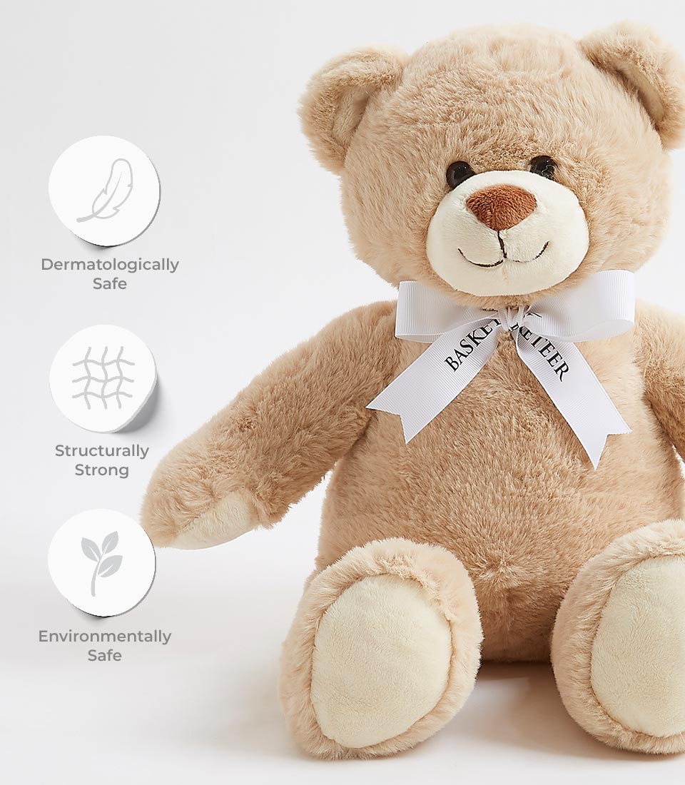 An adorable brown plush teddy bear with a white ribbon around its neck that reads 