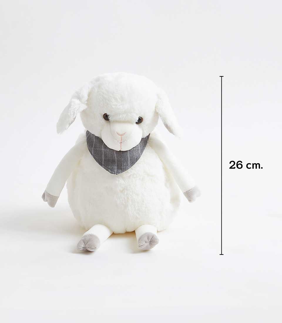 A fluffy sheep soft toy with a black scarf around its neck, sitting on a white surface. The plush toy has floppy ears, a small button nose, and grey hooves. The height of the toy is indicated to be 26 cm on the right side of the image.