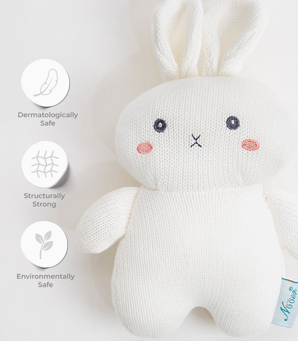 A white knitted bunny plush toy with cute facial features, including small black eyes, a tiny 