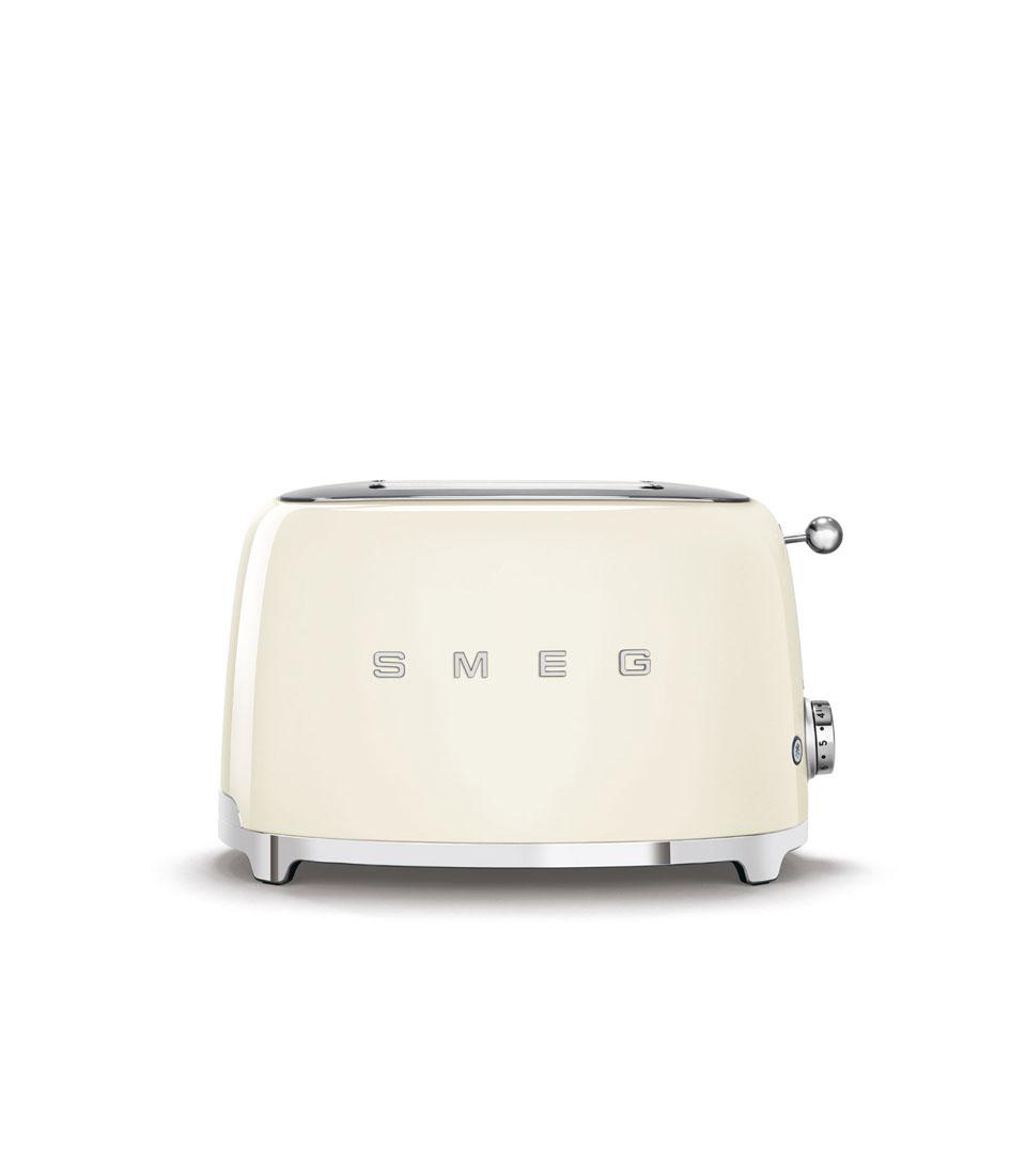 A retro-style SMEG Cream Toaster with two slots and a sleek, chrome finish on the base and controls. The SMEG logo is prominently displayed on the front. The toaster has a rounded design with a lever on the side.
